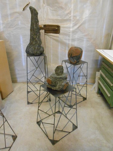 Three steel bases with sculptures