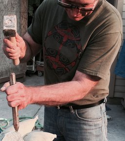 Note his grip on the chisel.  More control.